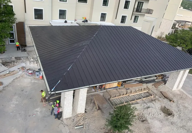 Metal roofing installation team working on a commercial building in Clairton